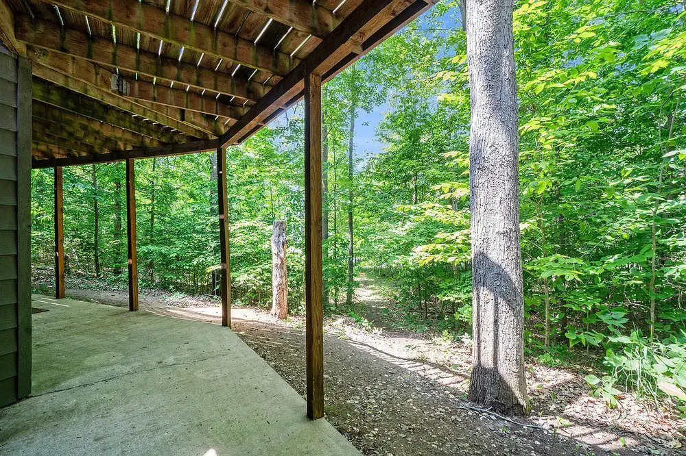 Dome home exterior showing elevated deck and forest setting near Burt Lake Michigan