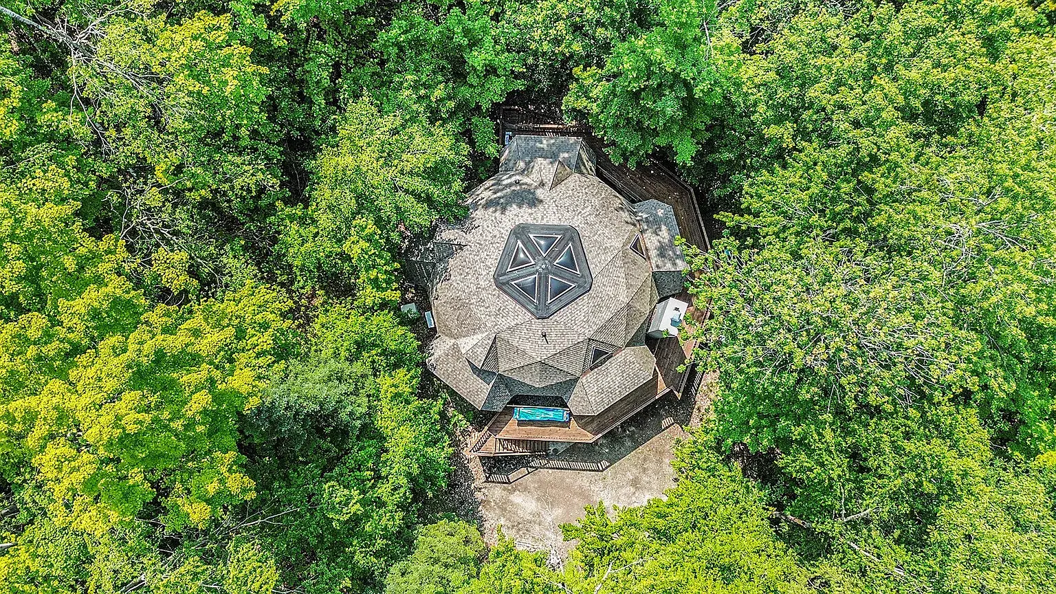 Geodesic dome vacation rental exterior surrounded by northern Michigan forest, Indian River MI
